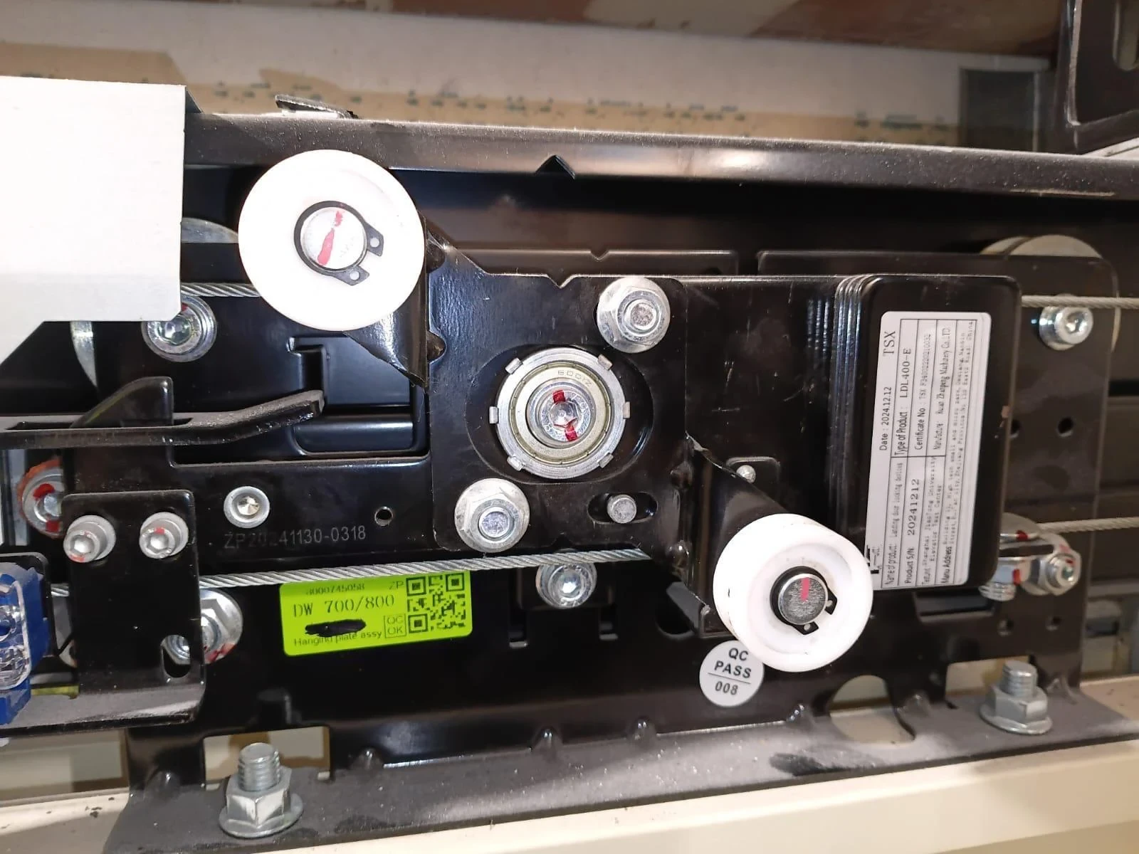 Close-up view labeling the major parts of an elevator door lock.