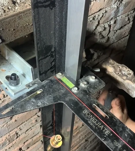 Elevator guide rail bracket installation on shaft wall